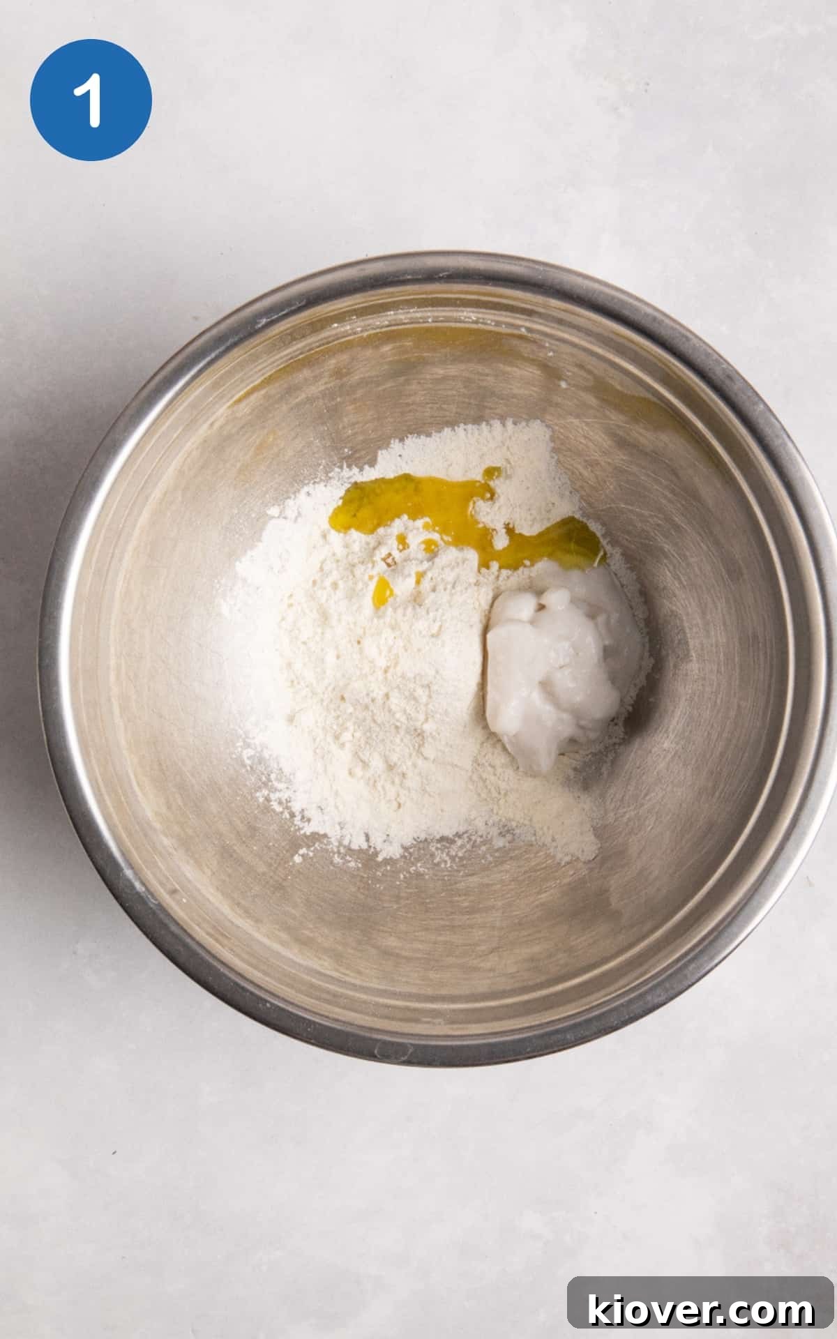 Flour, olive oil and yoghurt in a mixing bowl.