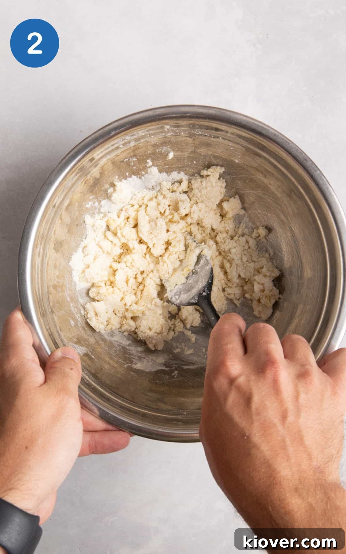 Hand mixing the ingredients for gluten free flatbread in a mixing bowl.