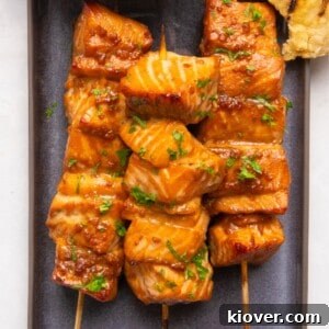 Asian salmon skewers on a plate.