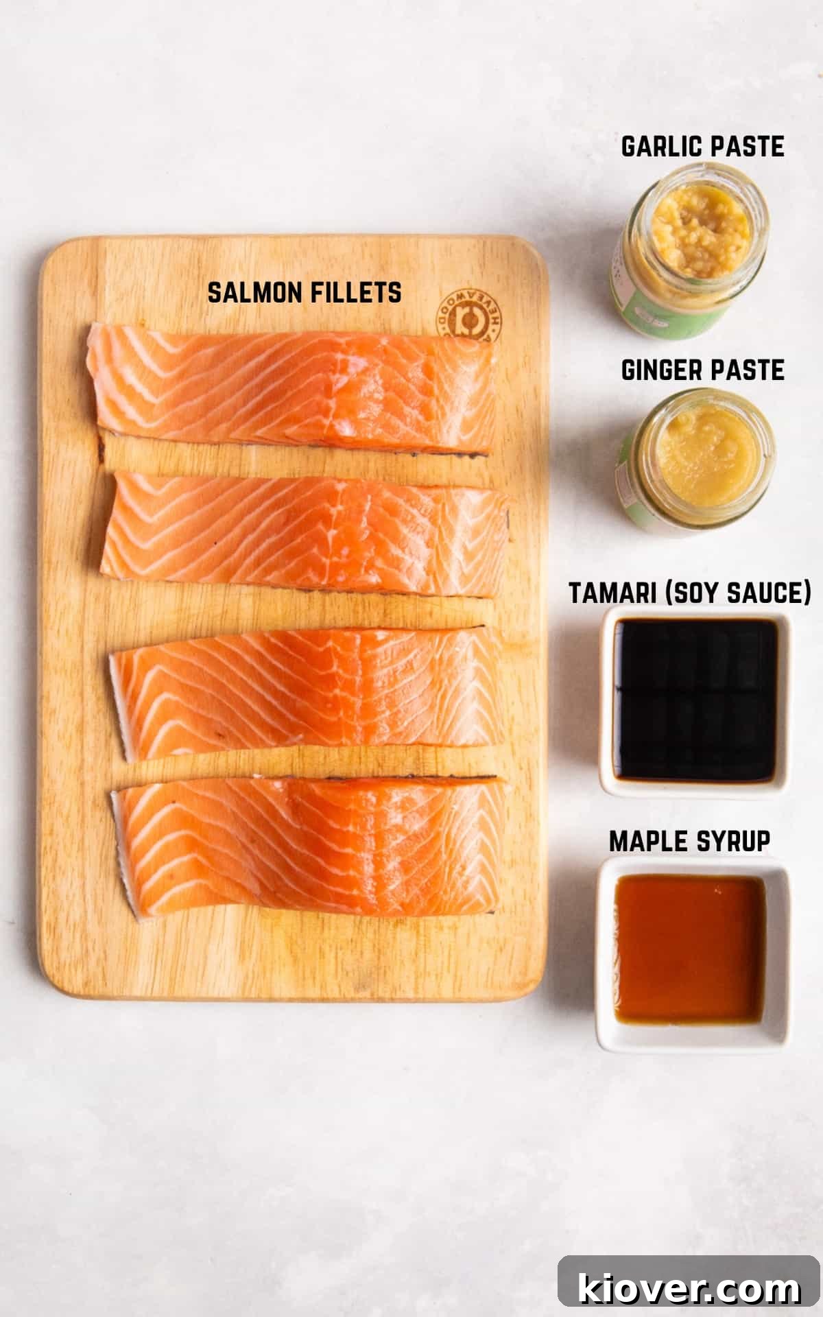Ingredients to make Asian Salmon Skewers on a white marble background.