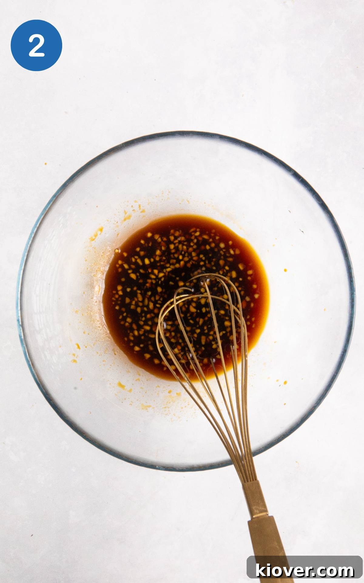 Brown sauce for Asian Salmon Skewers in a glass mixing bowl.