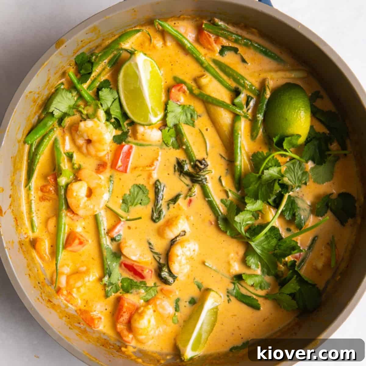 overhead shot of Thai red prawn curry in large shallow frying pan.