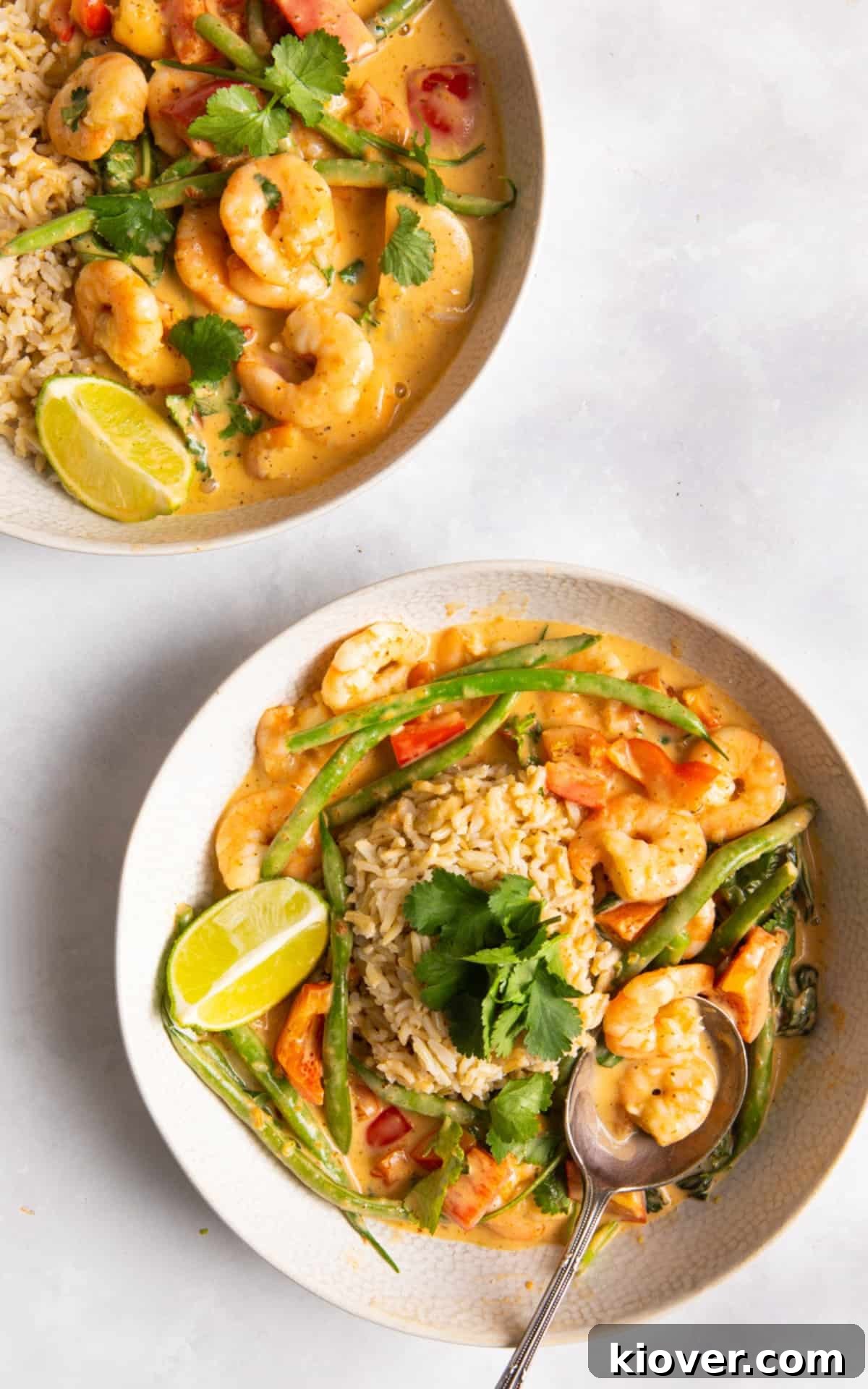 2 bowls of prawn curry in white bowls on white background.
