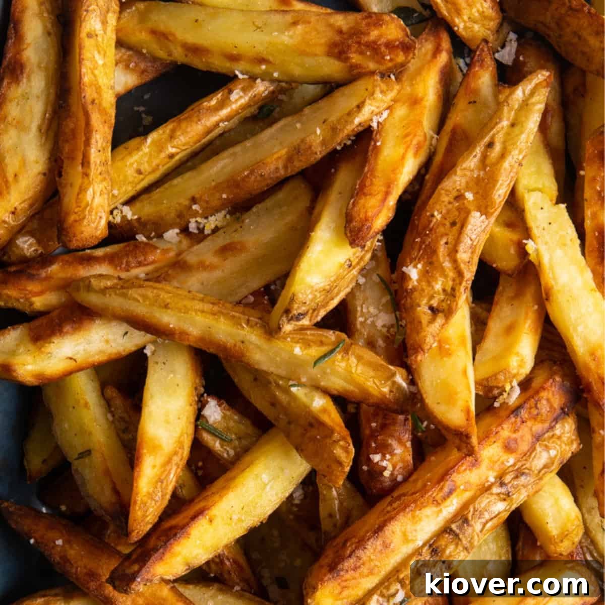 Crispy Air Fryer French Fries: Quick Homemade Recipe 2 close up shot of air fryer chips with salt on them.