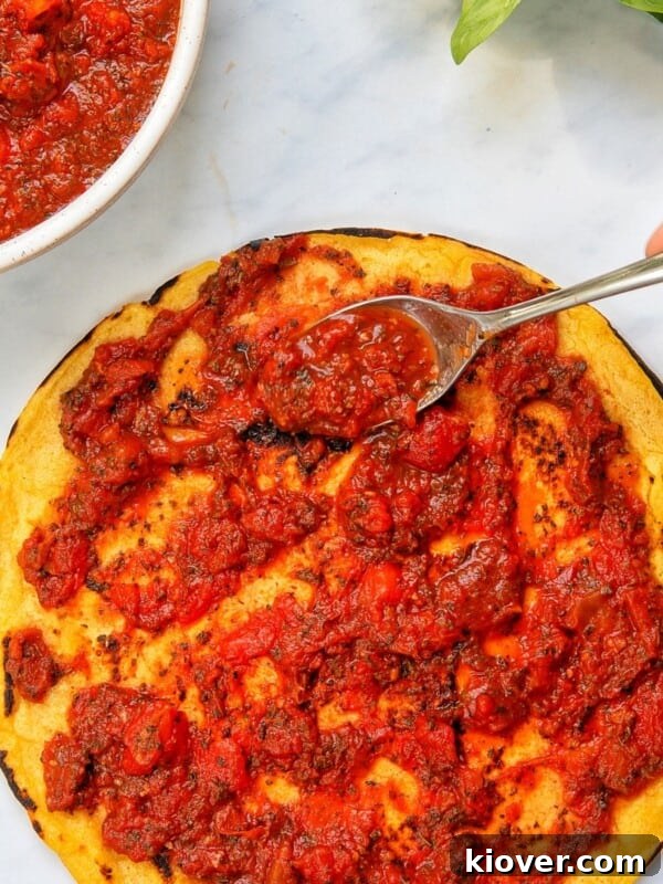 Creamy Vegan Béchamel Sauce Recipe for Pasta & Lasagna 9 pizza sauce topped on a pizza base