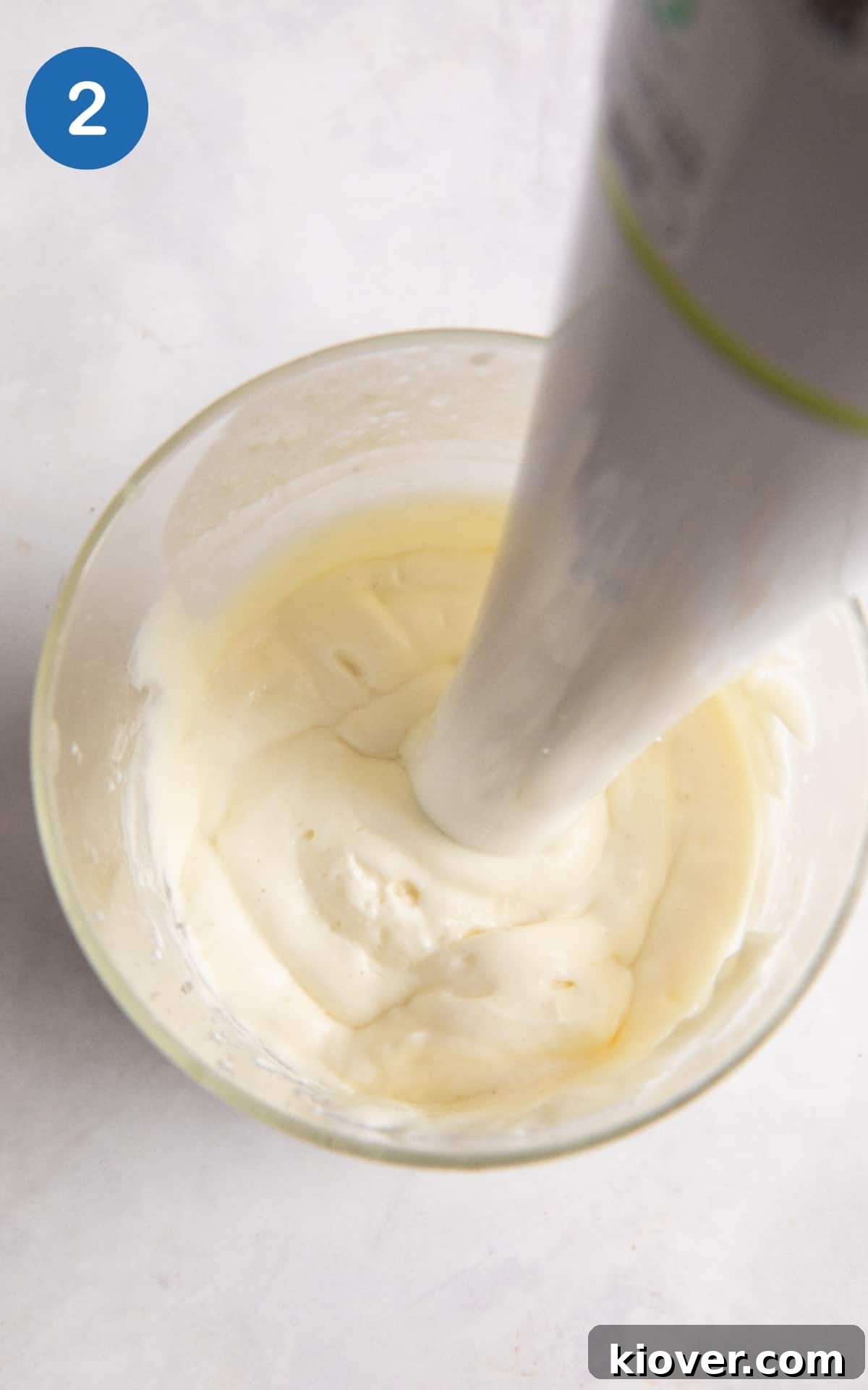 Creamy Vegan Mayonnaise Recipe: Homemade Egg-Free Mayo 5 creamy homemade vegan mayonnaise being blended in a glass jar with a hand blender.