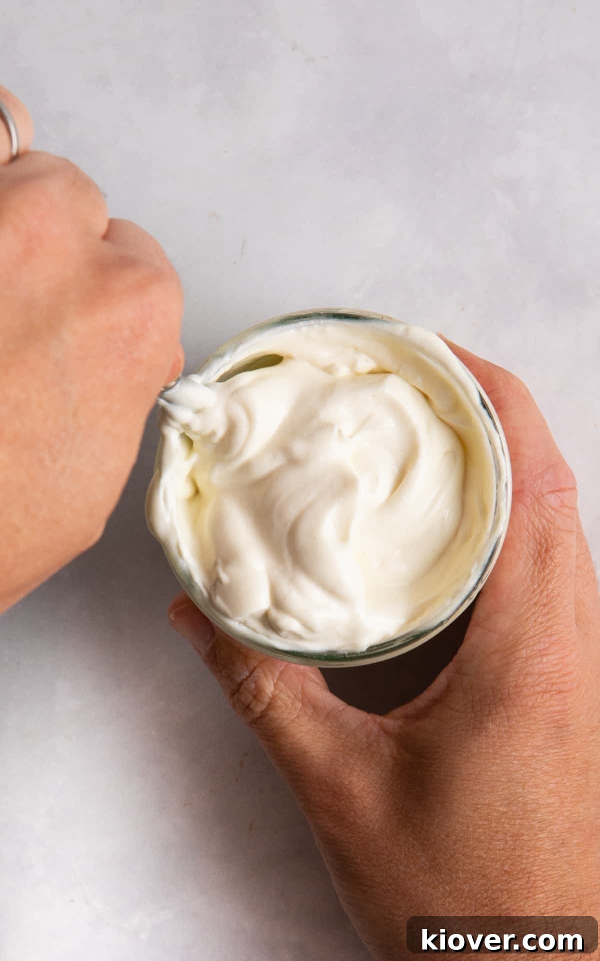 Creamy Vegan Mayonnaise Recipe: Homemade Egg-Free Mayo 6 homemade vegan mayonnaise served in a glass jar with hands stirring.