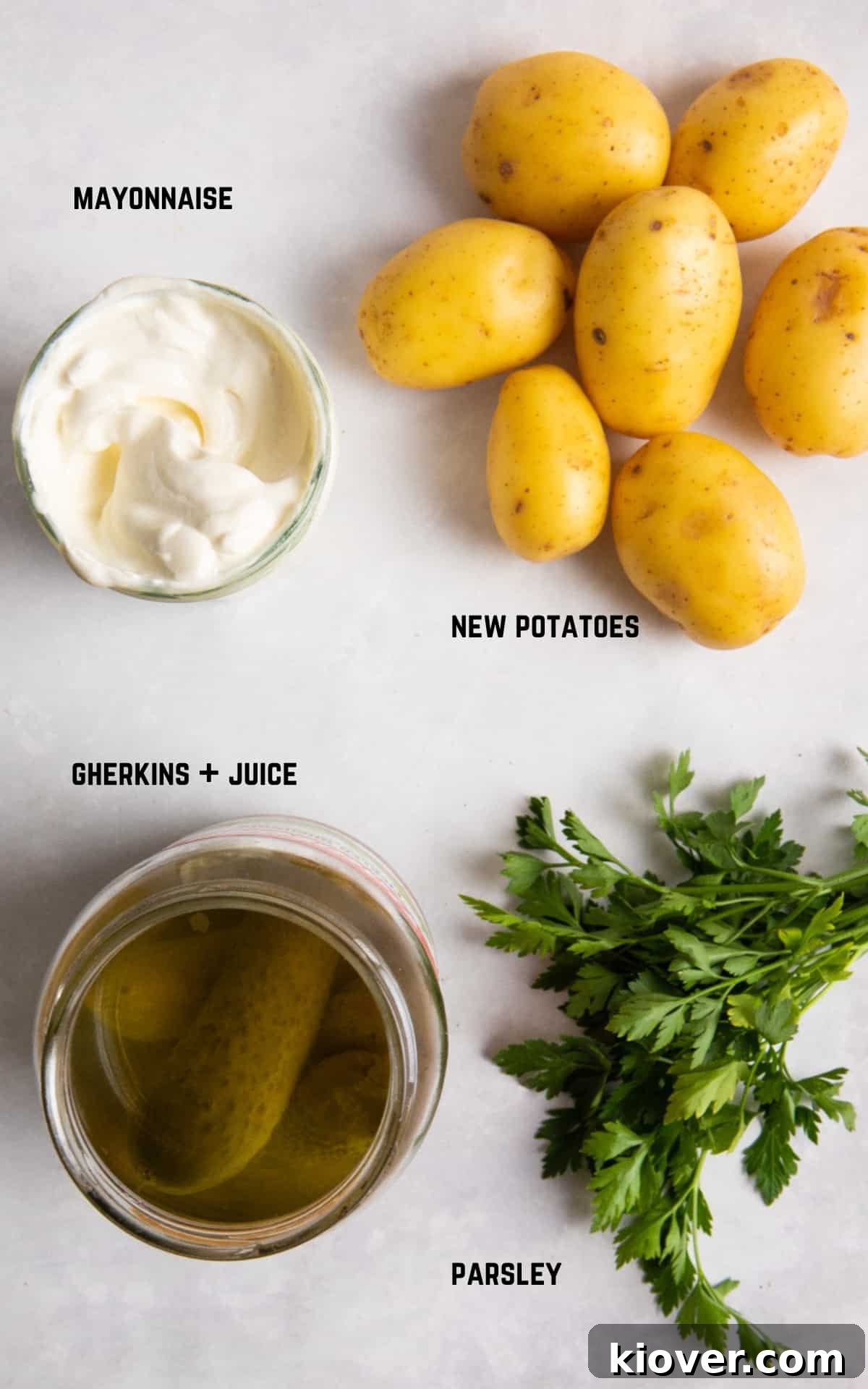 ingredient to make vegan potato salad laid out on white background / surface.