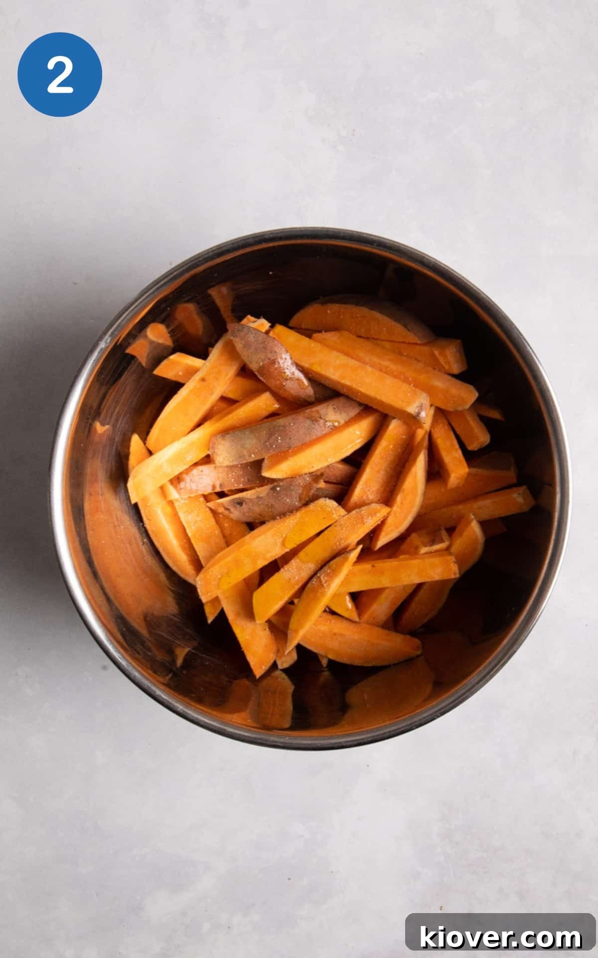 Sweet potato in large silver mixing bowl.