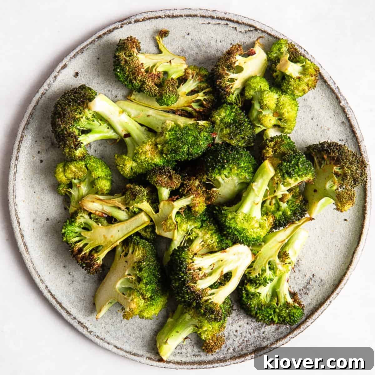 Crispy Air Fryer Broccoli Recipe — Quick Dinner Side 2 Air Fryer Broccoli on a grey plate.