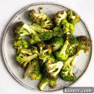 Crispy Air Fryer Broccoli Recipe — Quick Dinner Side 12 Air Fryer Broccoli on a grey plate.