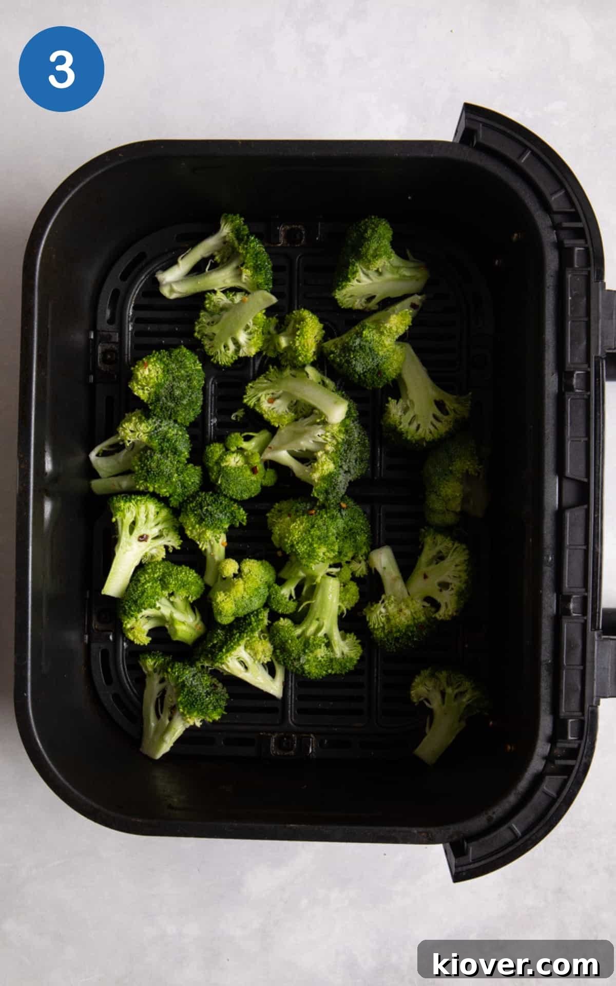 Crispy Air Fryer Broccoli Recipe — Quick Dinner Side 6 Broccoli in black air fryer before being cooked.