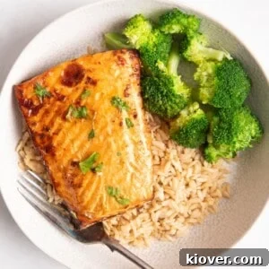 salmon on a bed of rice served with broccoli