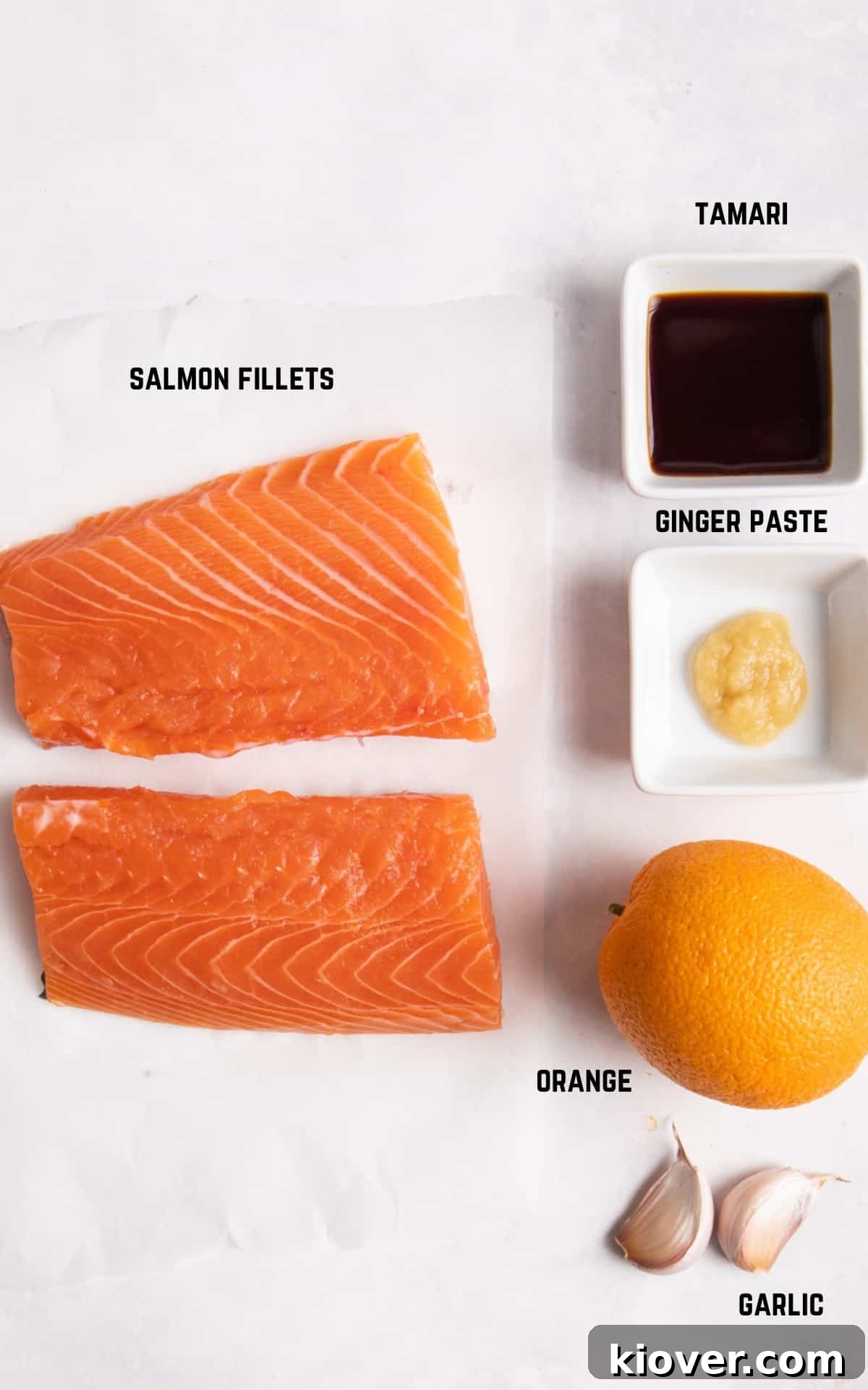 ingredients to make air fryer salmon on white background.