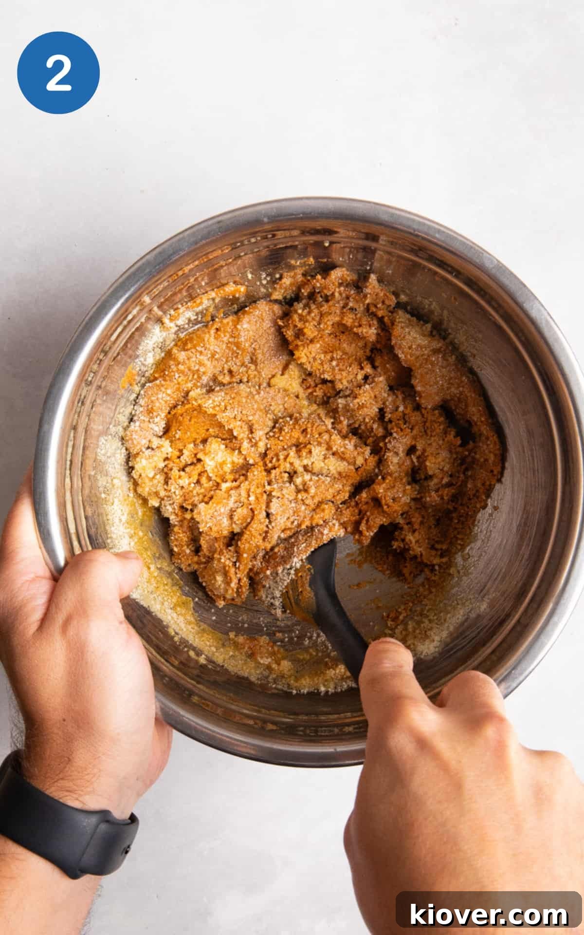 No-Bake Peanut Butter Protein Balls for Snacks & Desserts 5 Hand mixing the ingredients for peanut butter balls with spatula in a bowl.