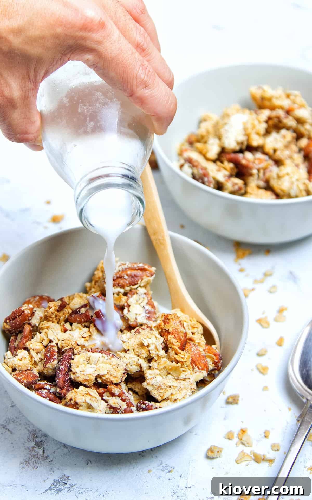 pouring milk into a bowl of peanut butter granola
