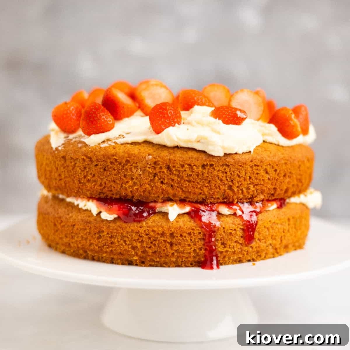 Gluten-Free Victoria Sponge Cake Recipe for Light, Fluffy Layers 2 Gluten Free Victoria Sponge on a white cake stand