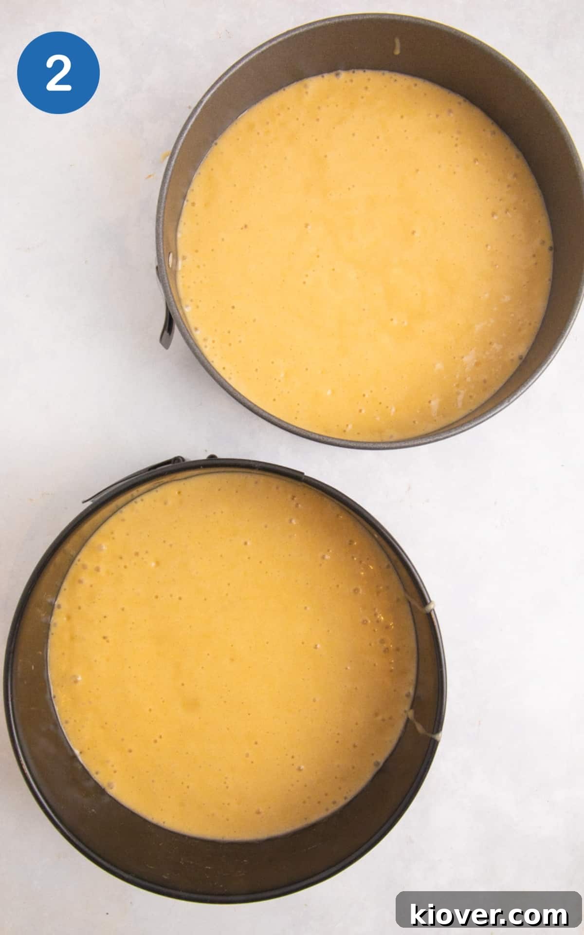 Gluten-Free Victoria Sponge Cake Recipe for Light, Fluffy Layers 5 sponge cake separated into 2 cake tins ready to bake