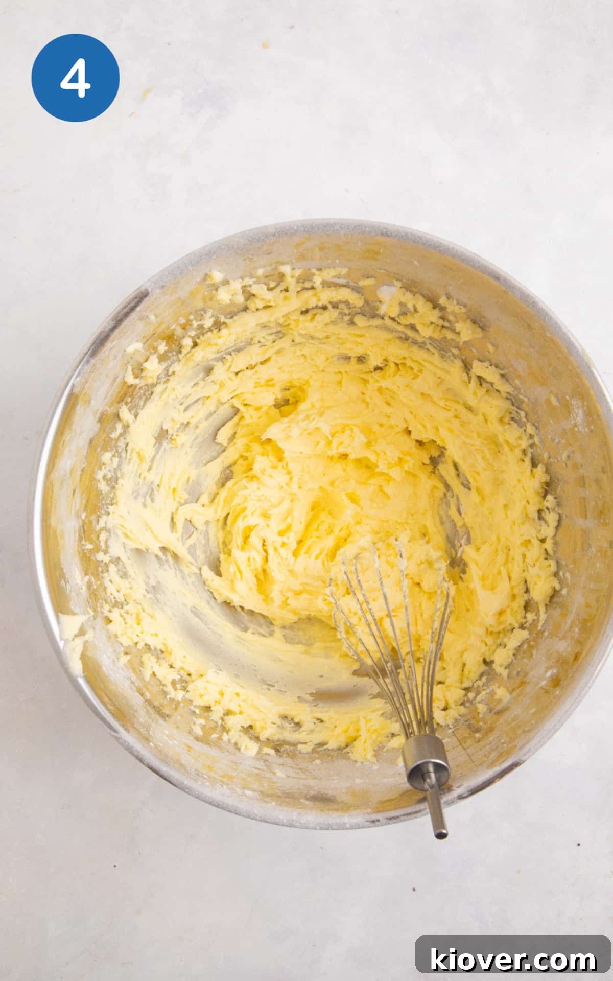 Gluten-Free Victoria Sponge Cake Recipe for Light, Fluffy Layers 7 vegan cake icing mixed in a silver mixing bowl
