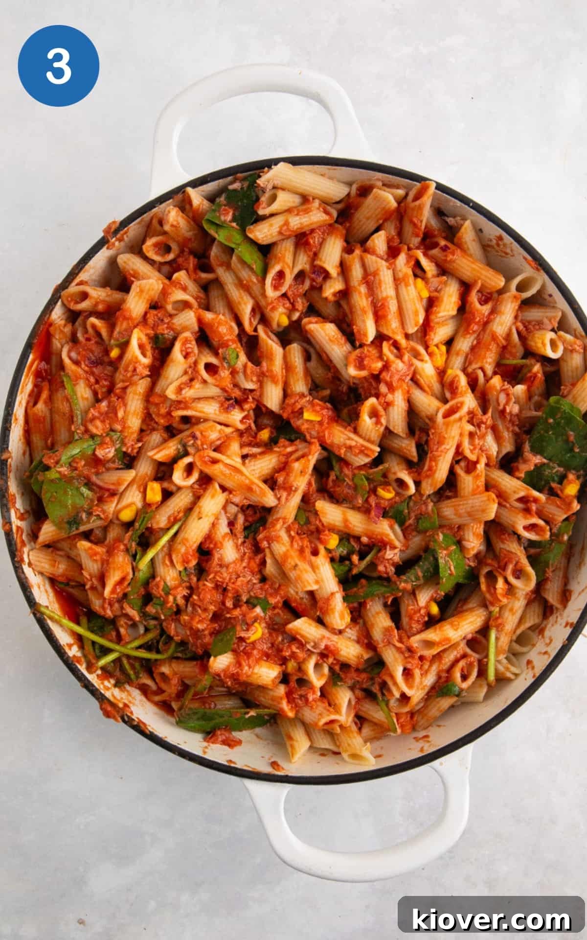 tuna pasta bake ingredients mixed together in a large white casserole dish.