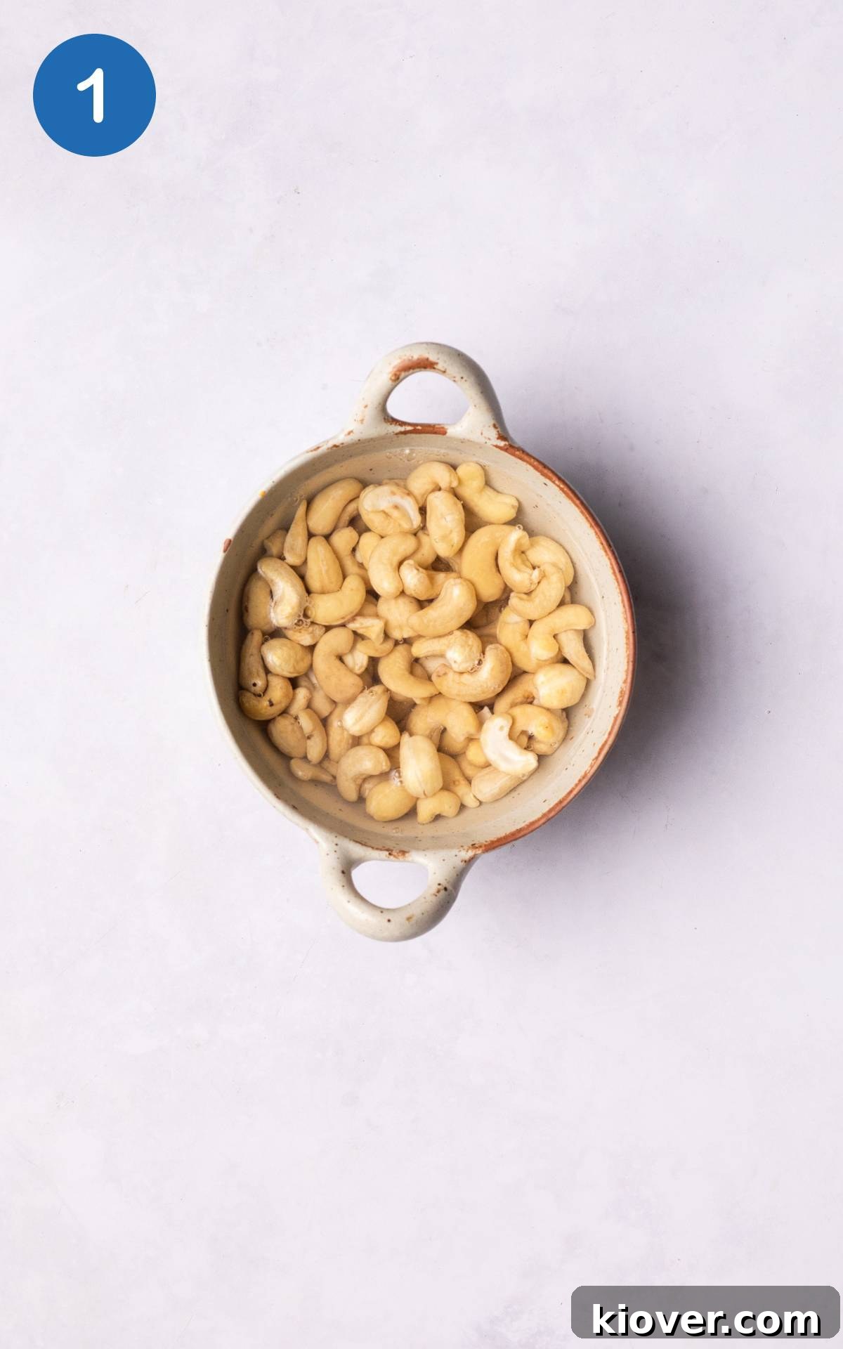 cashews soaking in a bowl with water.