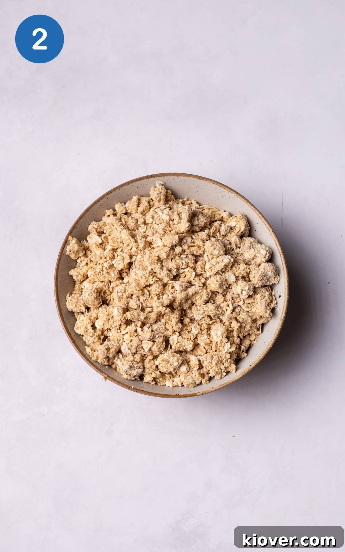 oats, maple syrup and butter mixed in a bowl.