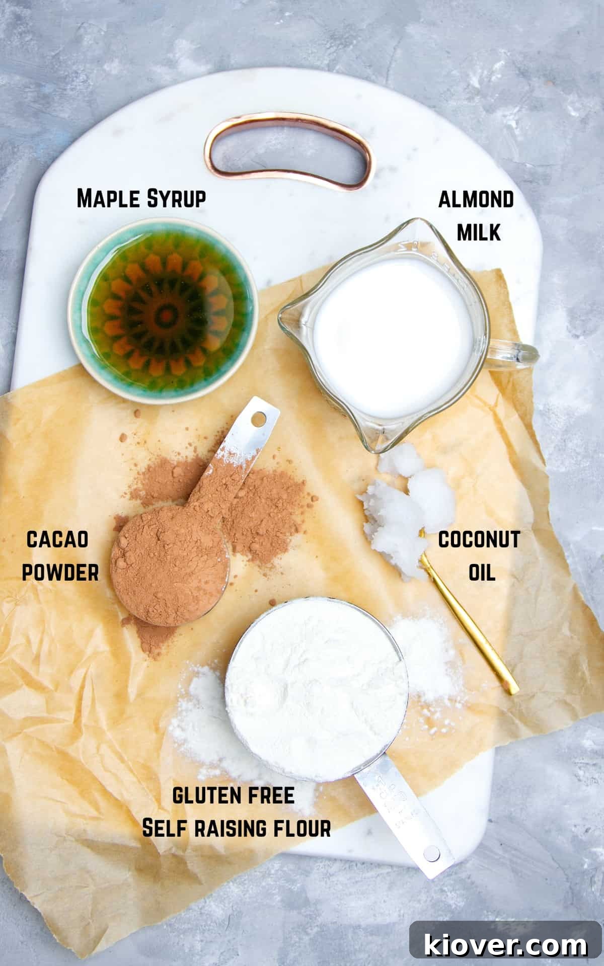 ingredients to make doughnuts on white chopping board.