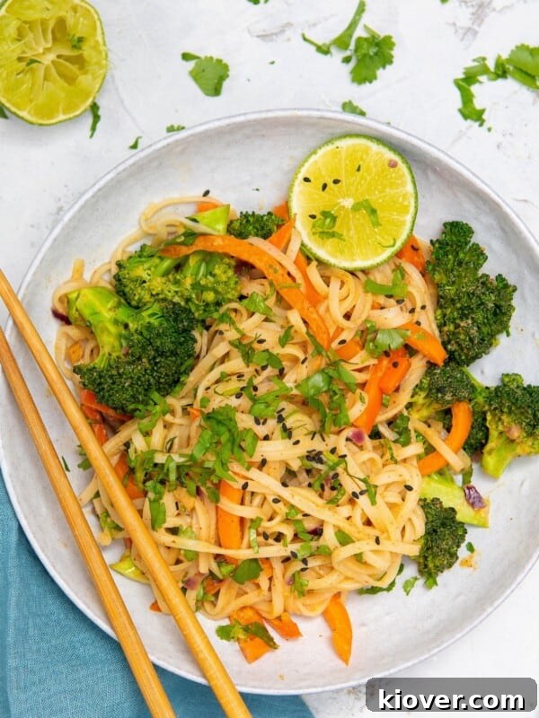 Creamy Vegan Laksa Recipe: Flavorful Plant-Based Coconut Curry Soup 12 peanut butter noodles with vegetables in a bowl.