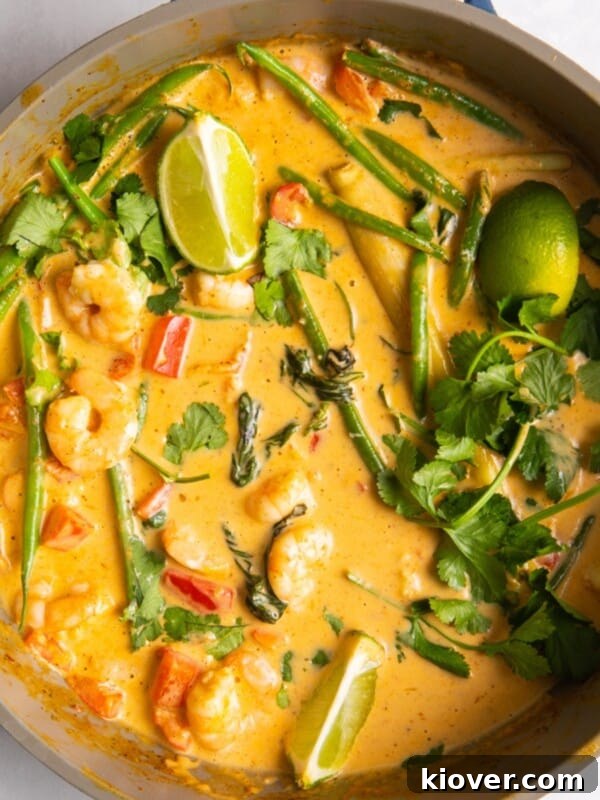 overhead shot of Thai red prawn curry in large shallow frying pan.