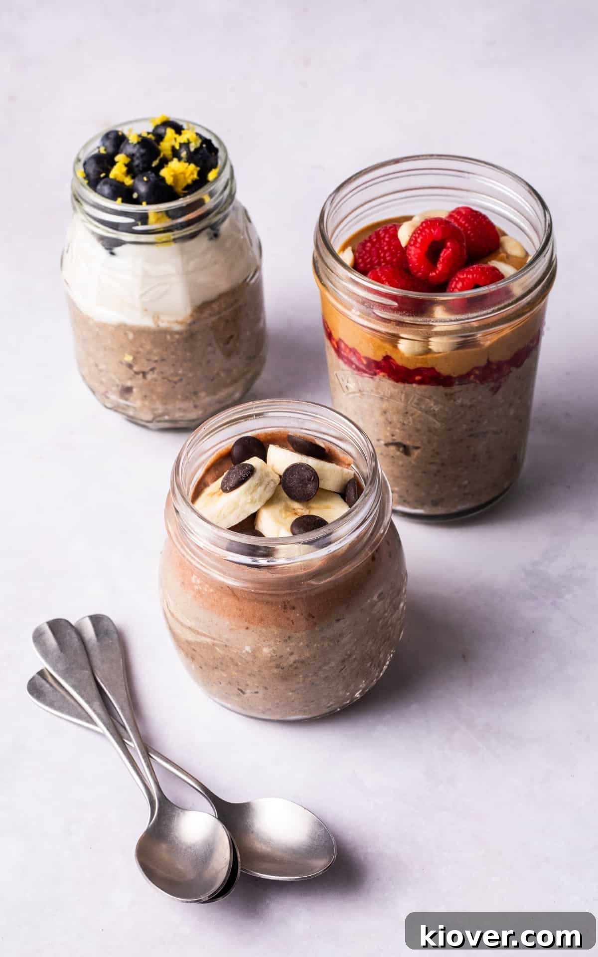 overnight oats with fruit toppings in glass jars.