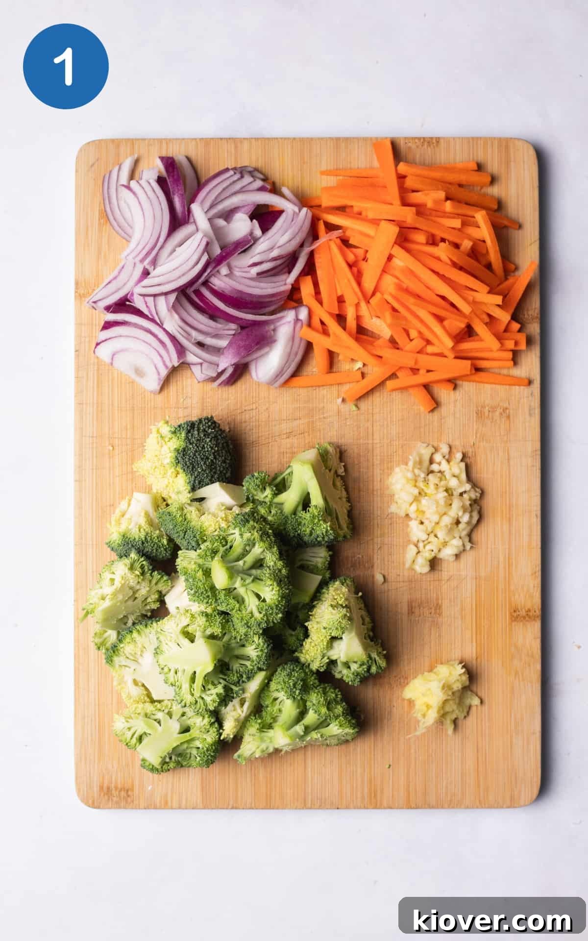 colourful chopped vegetables on a wooden cutting board.