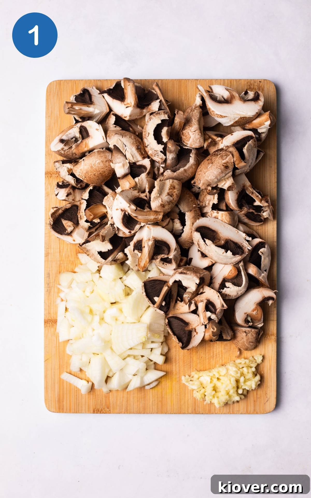 Creamy Wild Mushroom Soup Recipe for Cozy Weeknights 4 chopped vegetables on a cutting board.