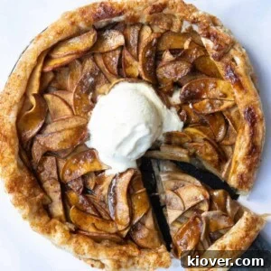 Circular Puff Pastry Apple Tart with scoop of ice-cream in centre.