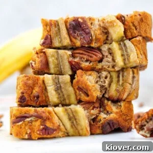 slices of banana bread on top of beach other on white surface with white background.
