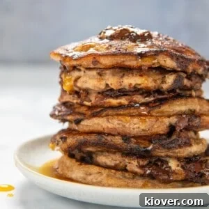 35 Delicious Gluten-Free Desserts for Every Occasion 31 gluten free banana pancakes stacked on a white plate