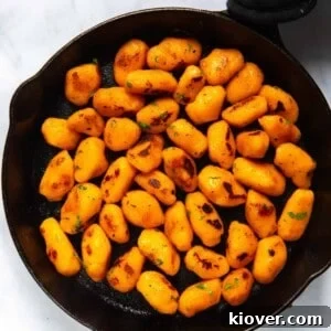 71 Top Gluten-Free Recipes for Every Meal 25 Sweet Potato Gnocchi in black frying pan. Pan is displayed on white background.