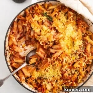 71 Top Gluten-Free Recipes for Every Meal 26 tuna pasta bake in a large white casserole dish served with a spoon.