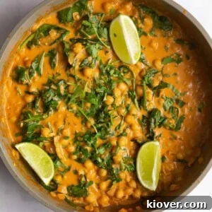 71 Top Gluten-Free Recipes for Every Meal 34 chickpea curry topped with fresh lime wedges and freshly chopped coriander in large pan.