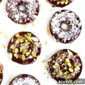 71 Top Gluten-Free Recipes for Every Meal 52 4 doughnuts on a white marble background with pistachio and coconut toppings.