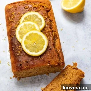 71 Top Gluten-Free Recipes for Every Meal 58 lemon drizzle cake topped with slices of lemon on concrete surface.