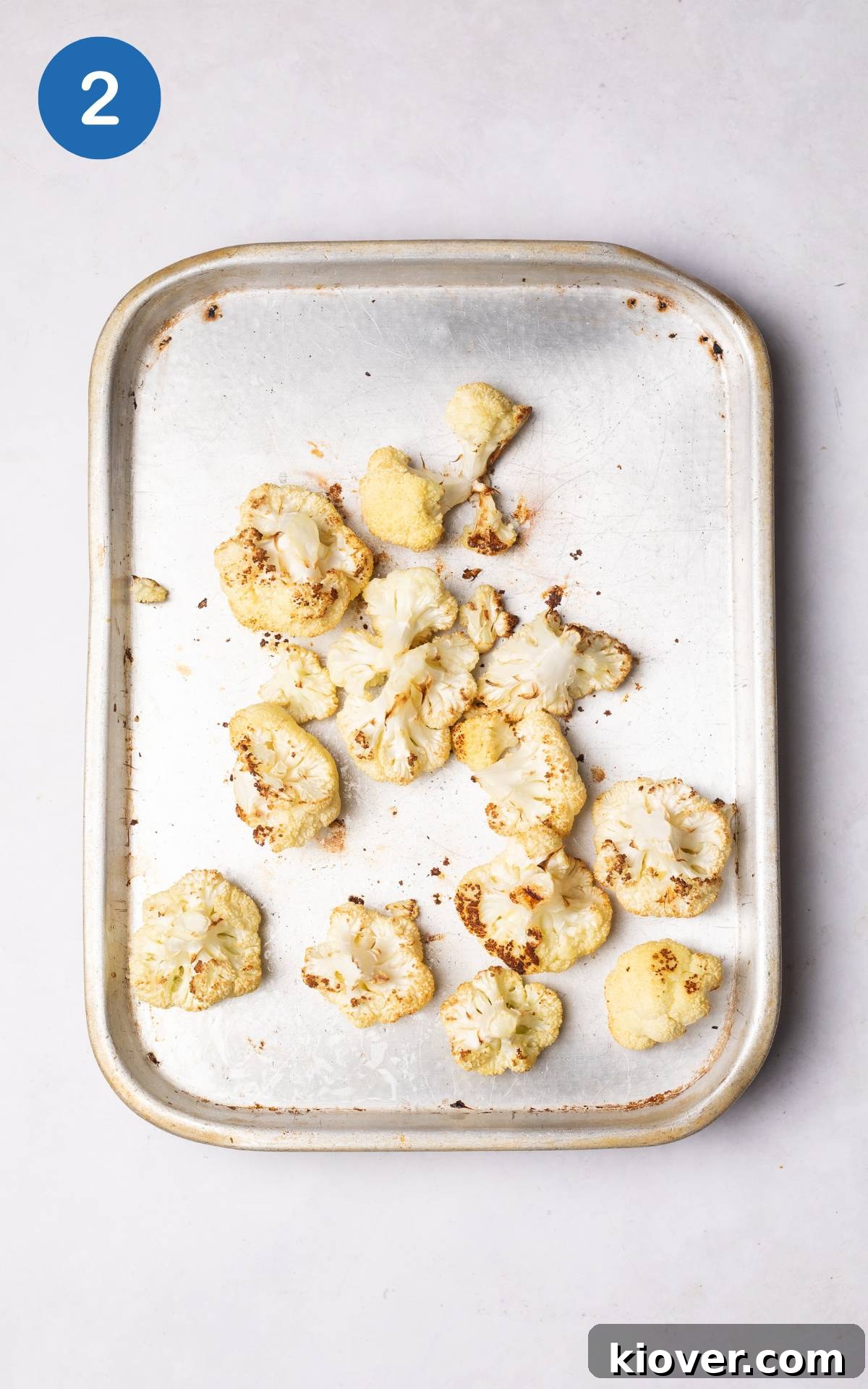 Creamy Roasted Cauliflower Soup Recipe for Cozy Nights 5 cauliflower florets on a baking tray drizzled with olive oil.