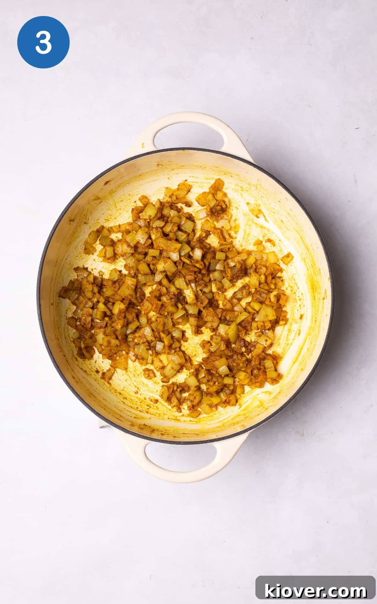 Creamy Roasted Cauliflower Soup Recipe for Cozy Nights 6 mixed onion, garlic, and ginger with spices in a pot.