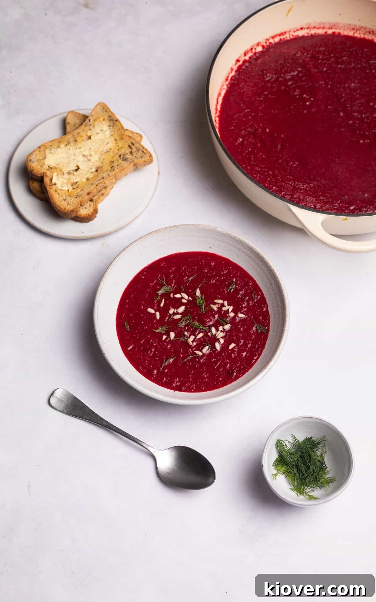 beetroot soup garnished with sunflower seeds.