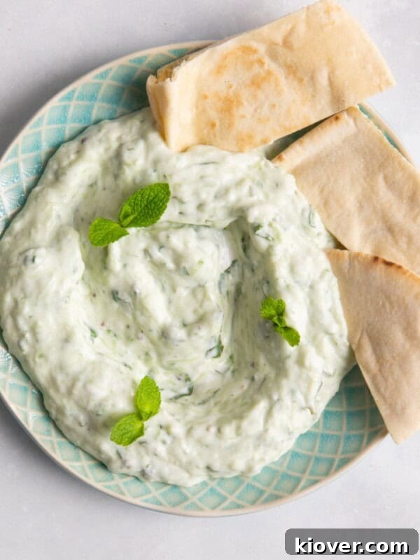 Crispy Air Fryer Cauliflower Recipe for a Perfect Side Dish 11 Tzatziki on blue plate accompanied with pittabread
