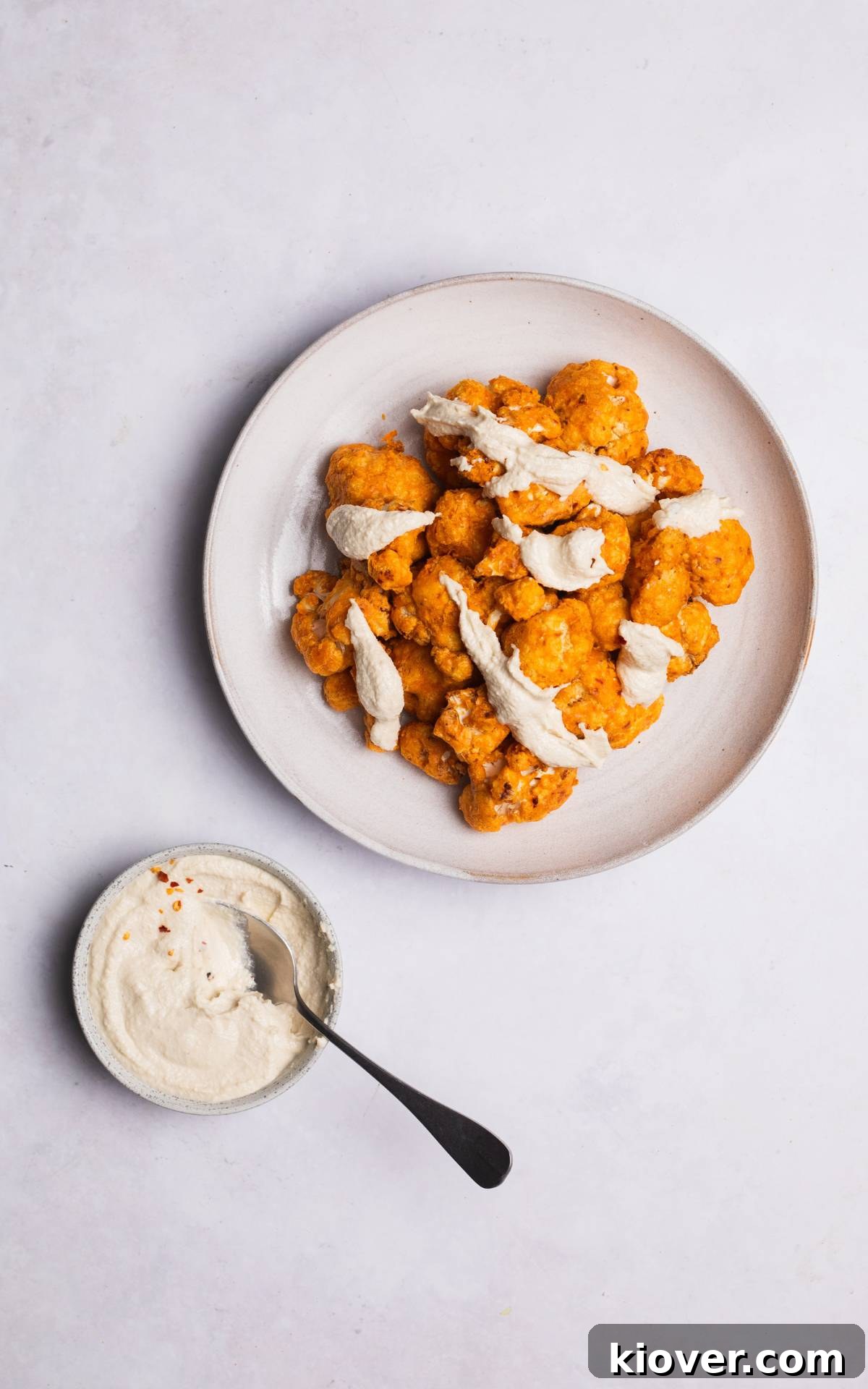 Crispy Air Fryer Cauliflower Recipe for a Perfect Side Dish 7 cauliflower made in air fryer with sauce on top.
