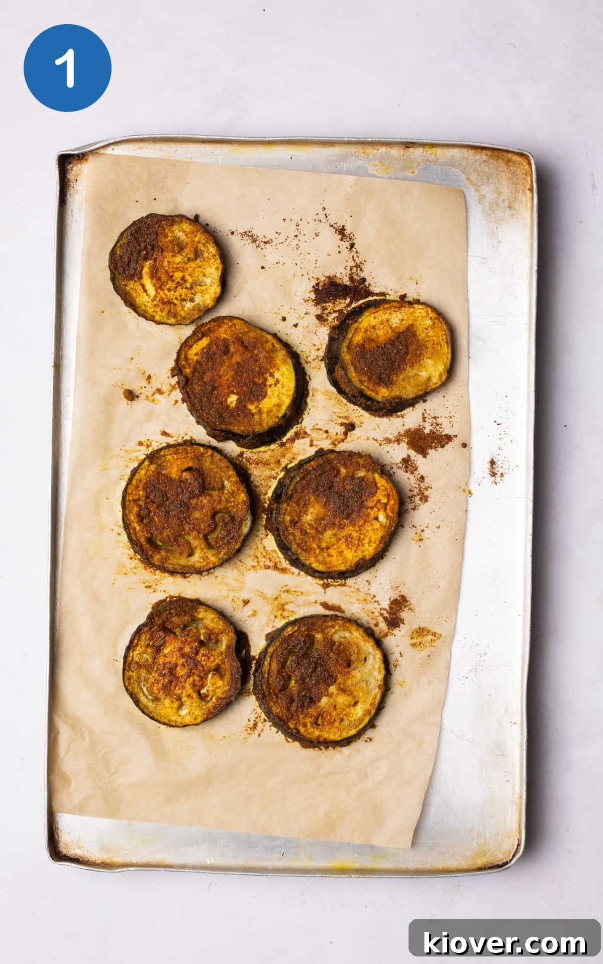 Creamy Spiced Eggplant Curry Recipe for Flavorful Weeknight Meals 4 aubergine slices on a baking tray.