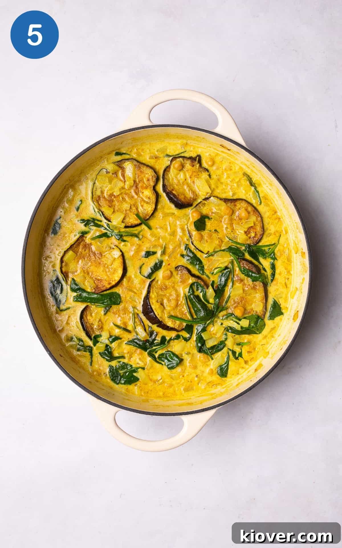 Creamy Spiced Eggplant Curry Recipe for Flavorful Weeknight Meals 8 eggplant curry with spinach in a pan.