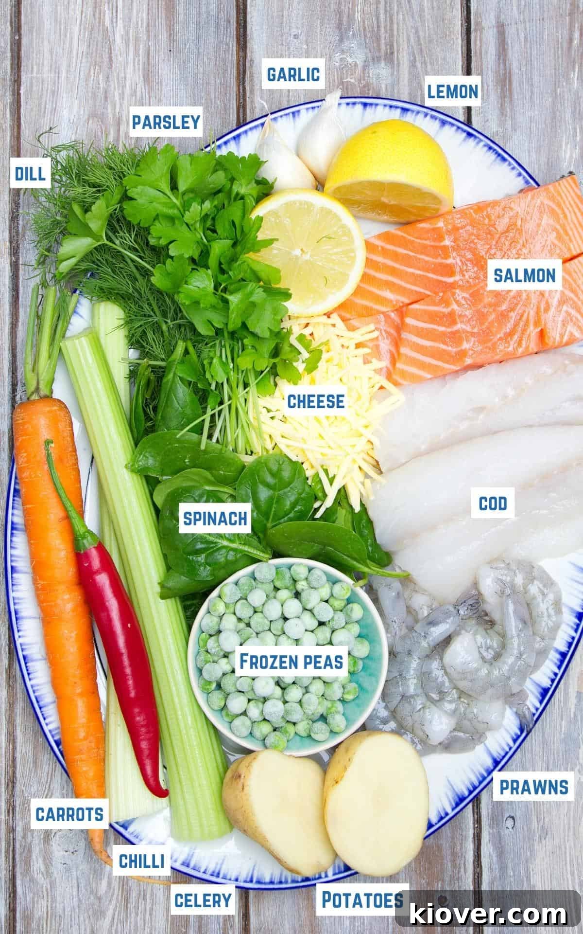Ingredients to make dairy free fish pie laid out on wooden table.