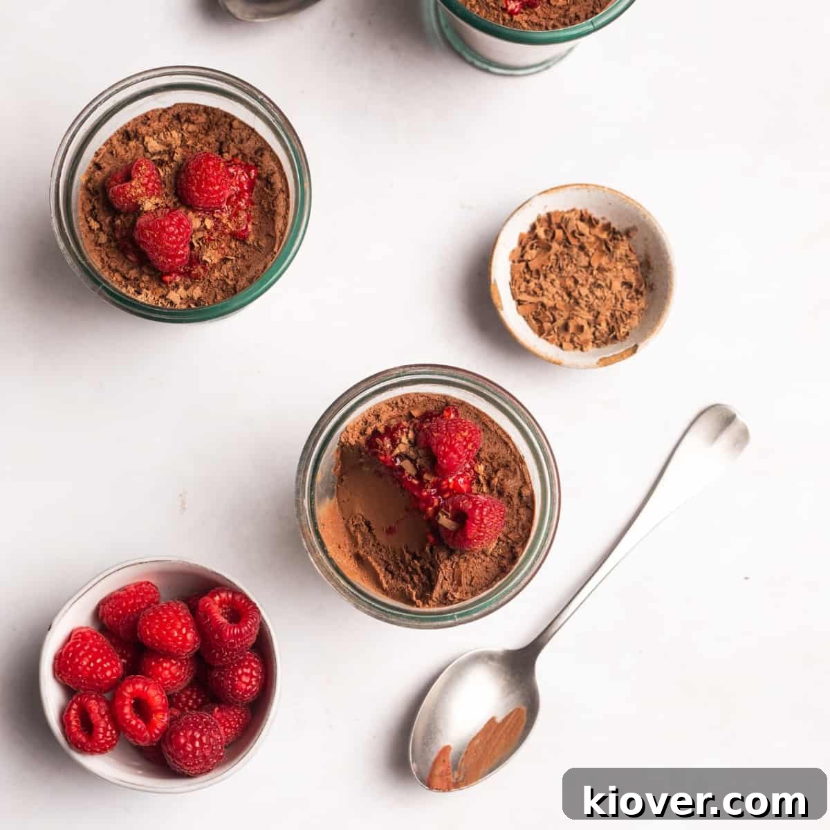 Creamy Vegan Chocolate Mousse Recipe for Decadent Desserts 2 vegan chocolate mousse with raspberries on top.