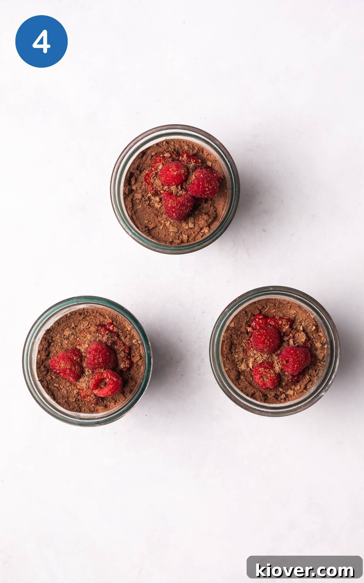 Creamy Vegan Chocolate Mousse Recipe for Decadent Desserts 7 chocolate mousse decorated with grated chocolate and raspberries.